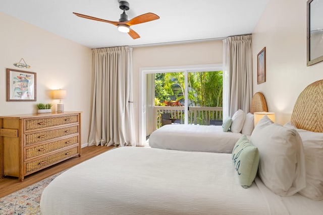 bedroom with access to outside, hardwood / wood-style floors, and ceiling fan