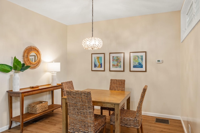 dining room featuring hardwood / wood-style floors and a notable chandelier