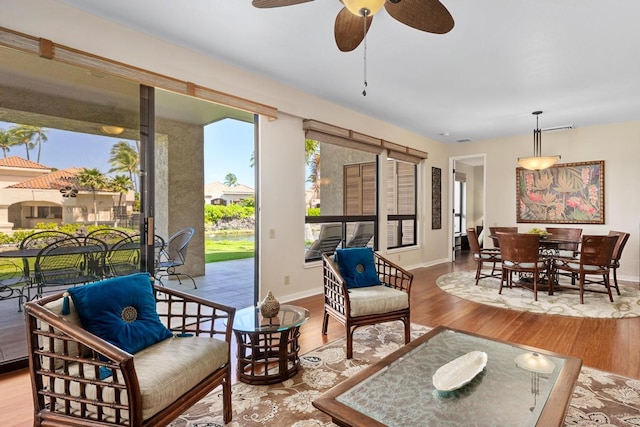 69-1035 Keana Pl Unit 113, Waikoloa, HI 96738 - living area with healthy amount of natural light, wood finished floors, ceiling fan, and baseboards