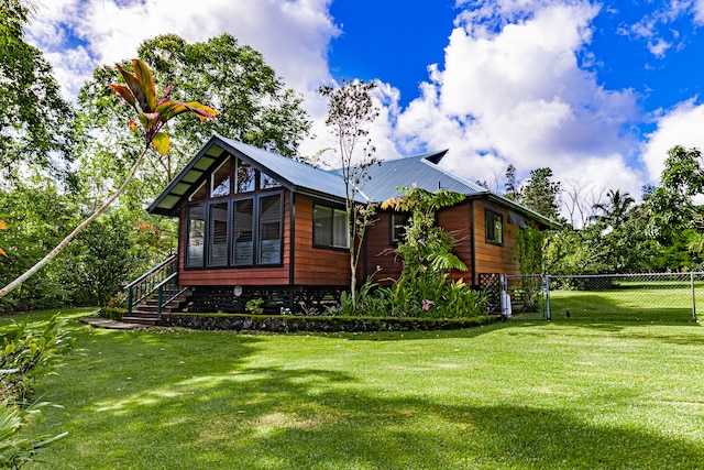 rear view of property featuring a yard