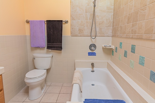 bathroom featuring a bathtub, toilet, tile patterned floors, and tile walls