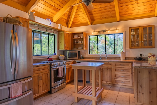 kitchen with wood ceiling, light tile patterned flooring, sink, lofted ceiling with beams, and stainless steel appliances