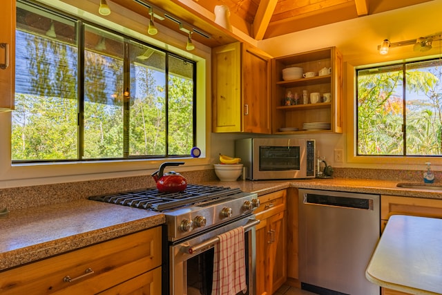 kitchen with wood ceiling, light stone countertops, vaulted ceiling with beams, sink, and stainless steel appliances