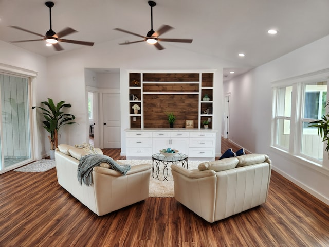 living room with dark hardwood / wood-style floors, ceiling fan, and lofted ceiling