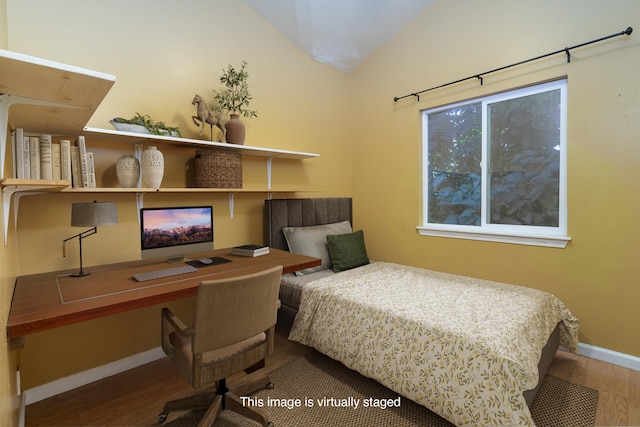 bedroom featuring hardwood / wood-style flooring and vaulted ceiling