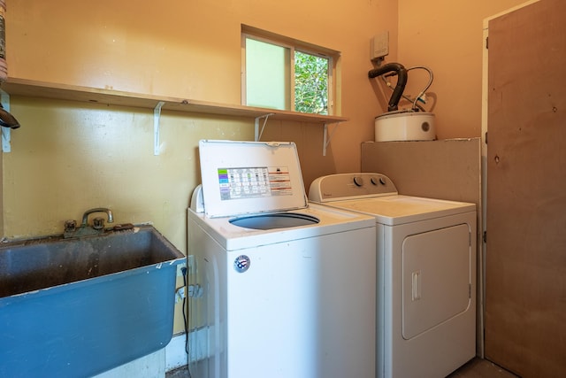 washroom with independent washer and dryer and sink