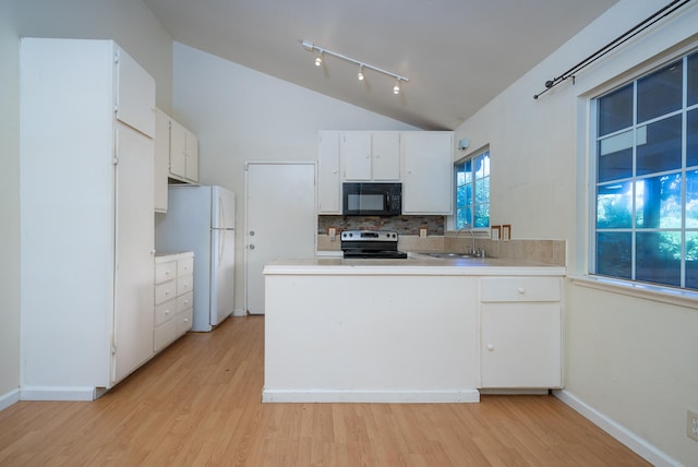 kitchen with white cabinetry, sink, white refrigerator, lofted ceiling, and stainless steel electric range