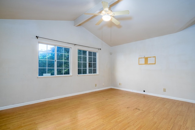 empty room featuring wood-type flooring, lofted ceiling with beams, and ceiling fan