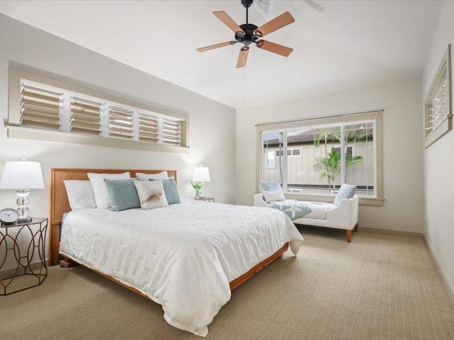 carpeted bedroom featuring lofted ceiling, ceiling fan, and baseboards