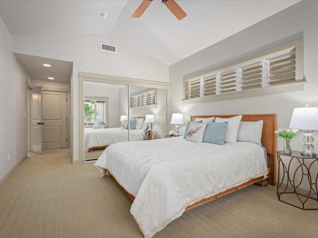 bedroom with carpet floors, visible vents, a ceiling fan, vaulted ceiling, and a closet