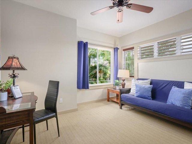 carpeted office featuring ceiling fan and baseboards