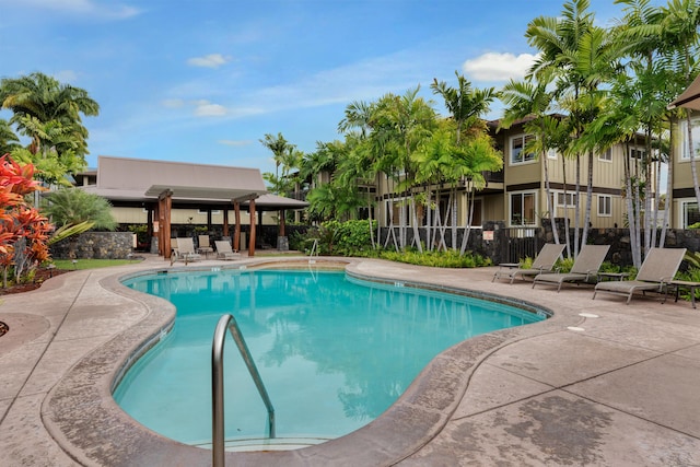 pool featuring a patio area and fence