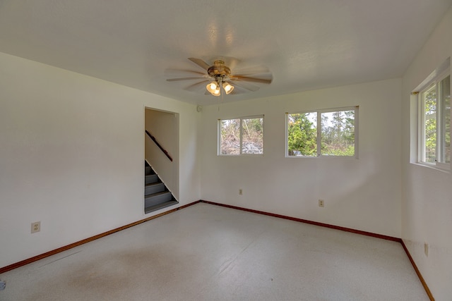 spare room featuring a wealth of natural light and ceiling fan