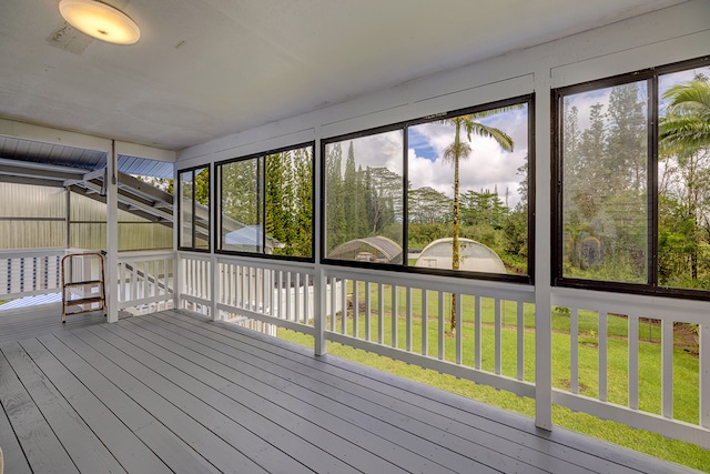 unfurnished sunroom with lofted ceiling and plenty of natural light