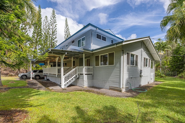 view of front facade with a front yard and a carport