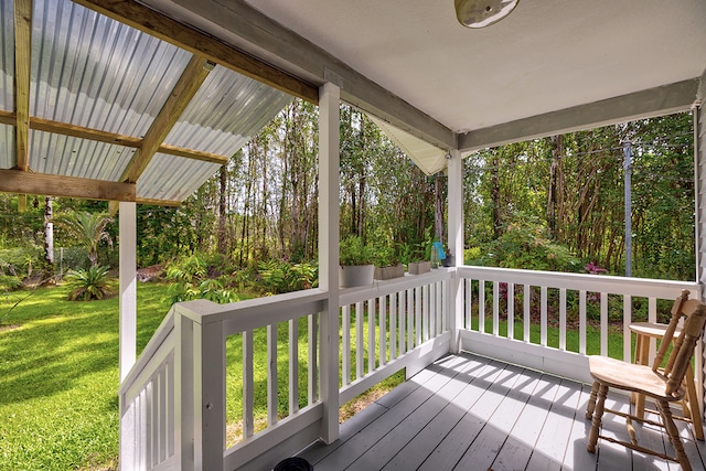 wooden deck with a lawn