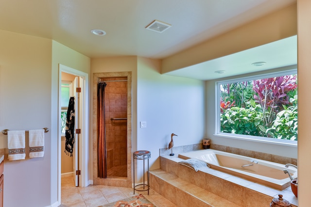 bathroom with independent shower and bath and tile patterned flooring