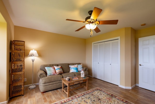 living room featuring hardwood / wood-style flooring and ceiling fan