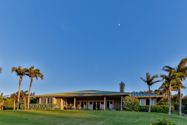 rear view of property featuring a yard