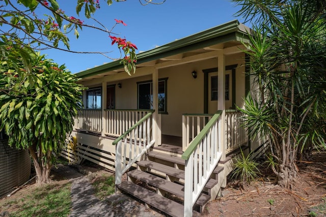 doorway to property featuring covered porch