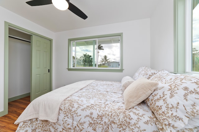 bedroom with a closet, wood-type flooring, and ceiling fan