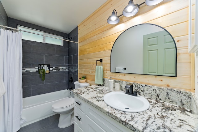 full bathroom featuring toilet, tile patterned floors, wooden walls, vanity, and shower / bathtub combination with curtain