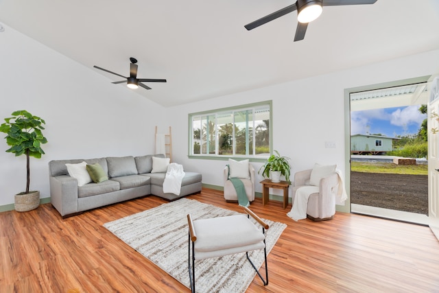 living room featuring vaulted ceiling, light wood-type flooring, and ceiling fan