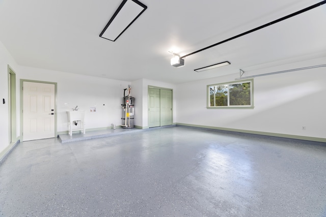 garage with a garage door opener and strapped water heater