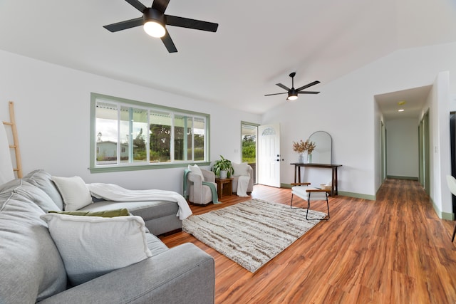 living room with hardwood / wood-style floors, vaulted ceiling, and ceiling fan