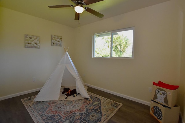 playroom featuring ceiling fan and dark hardwood / wood-style flooring