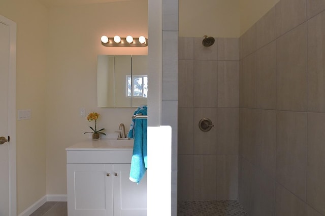 bathroom with vanity and tiled shower