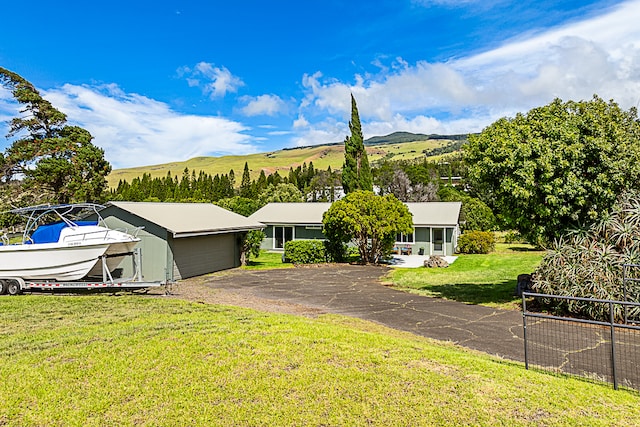 single story home featuring a mountain view, a garage, and a front yard