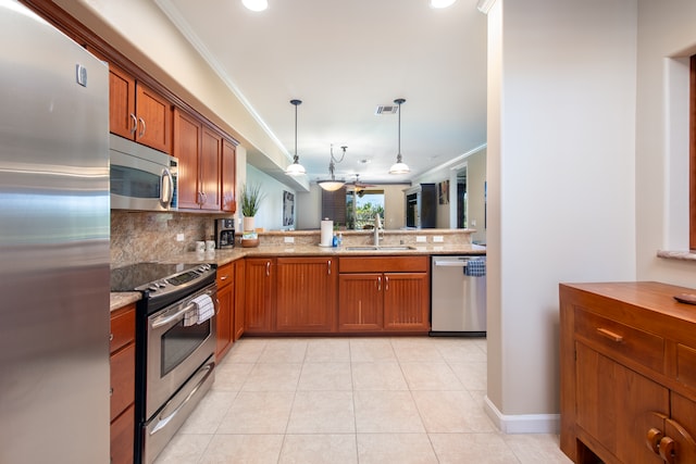 kitchen featuring tasteful backsplash, crown molding, stainless steel appliances, hanging light fixtures, and sink