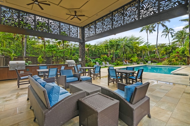 view of patio with a grill, area for grilling, ceiling fan, and a fenced in pool