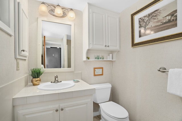 bathroom featuring toilet and vanity