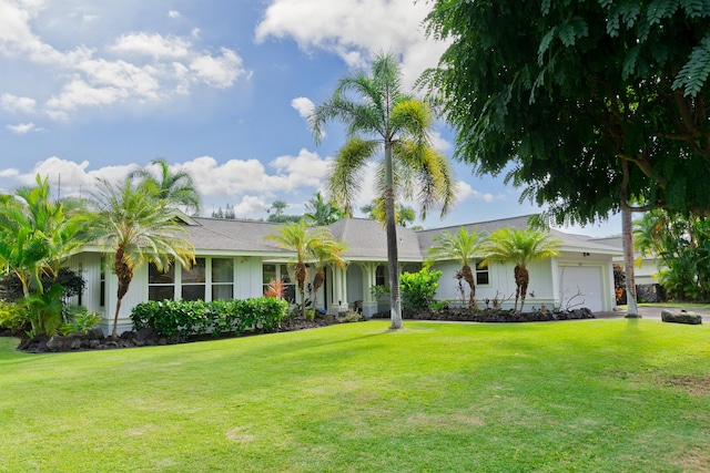 ranch-style home featuring a garage and a front lawn