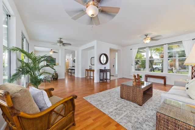 living room featuring wood-type flooring and ceiling fan