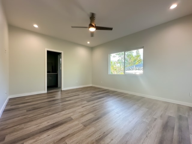 empty room featuring wood-type flooring and ceiling fan