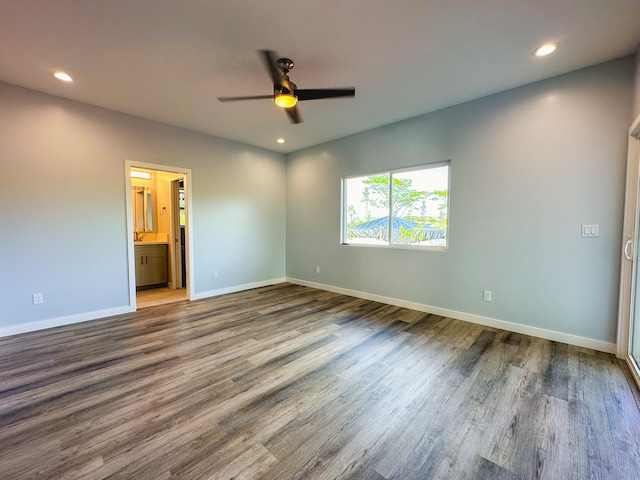 empty room with ceiling fan and hardwood / wood-style floors