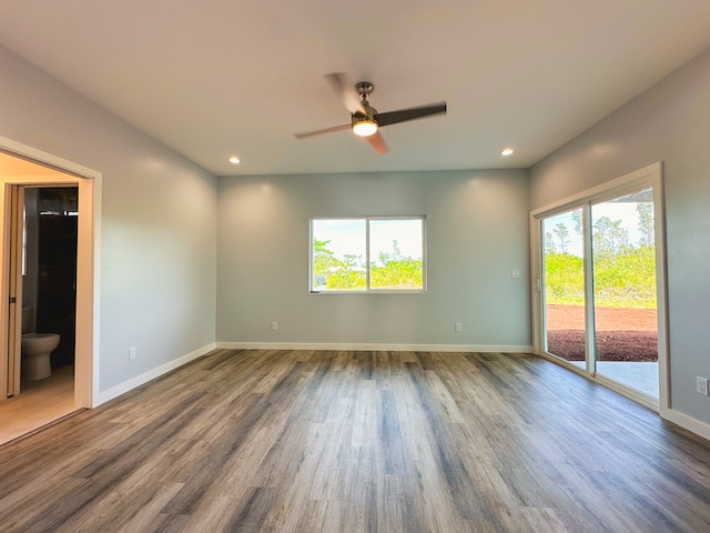 empty room featuring hardwood / wood-style floors, ceiling fan, and plenty of natural light