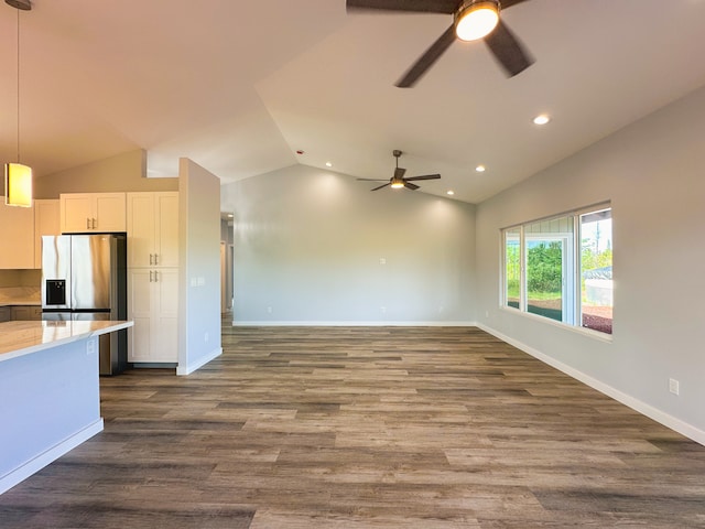 kitchen with white cabinetry, lofted ceiling, pendant lighting, stainless steel fridge with ice dispenser, and dark hardwood / wood-style floors