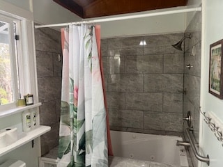 bathroom featuring shower / bath combination with curtain