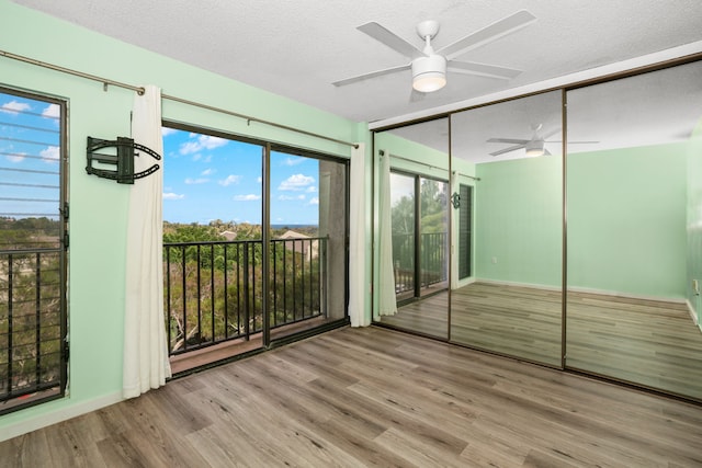 unfurnished bedroom featuring a closet, ceiling fan, a textured ceiling, and light hardwood / wood-style floors