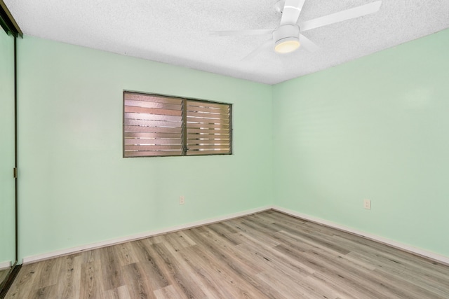 spare room featuring ceiling fan, a textured ceiling, and light hardwood / wood-style floors