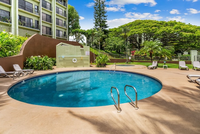 view of swimming pool with a patio area