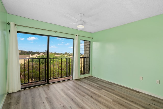 unfurnished room with light wood-type flooring, a textured ceiling, and ceiling fan