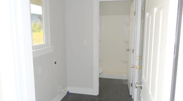 hallway featuring baseboards