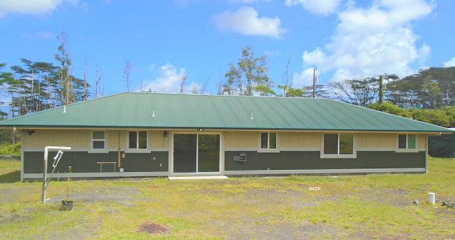 back of property featuring a lawn