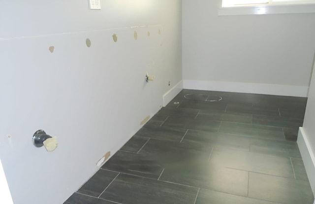 laundry area featuring baseboards