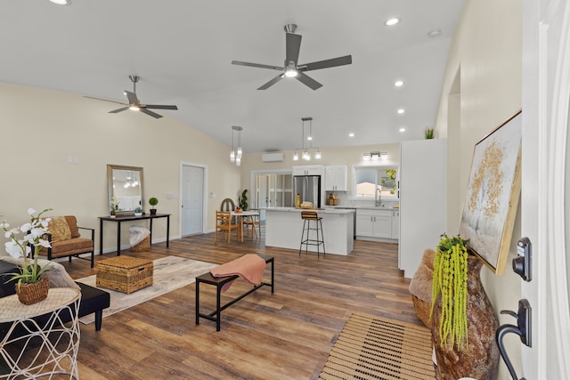 living room with hardwood / wood-style floors, sink, high vaulted ceiling, and ceiling fan